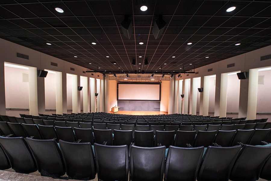 Photo of McConomy Auditorium from the back of the theater facing the stage and projection screen